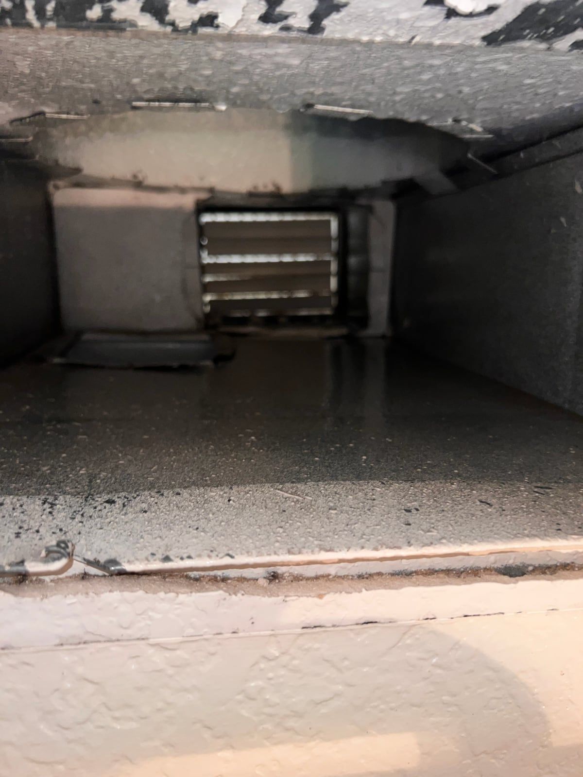 The same supply duct after cleaning, with the dust layer removed and bare metal showing